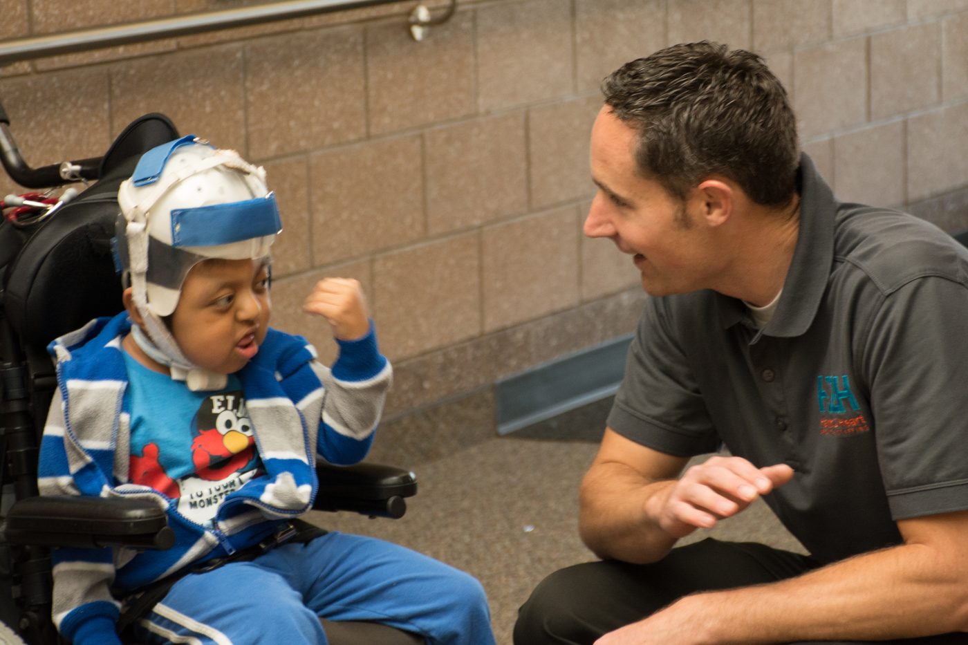 An H2H nurse connecting with a student in the classroom